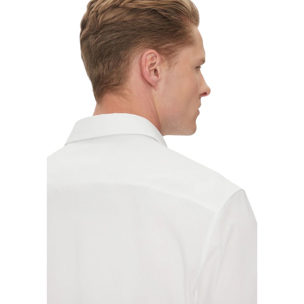 Back view of man wearing Calvin Klein White Organic Cotton Shortsleeve Shirt, highlighting minimalist design and comfortable fit.