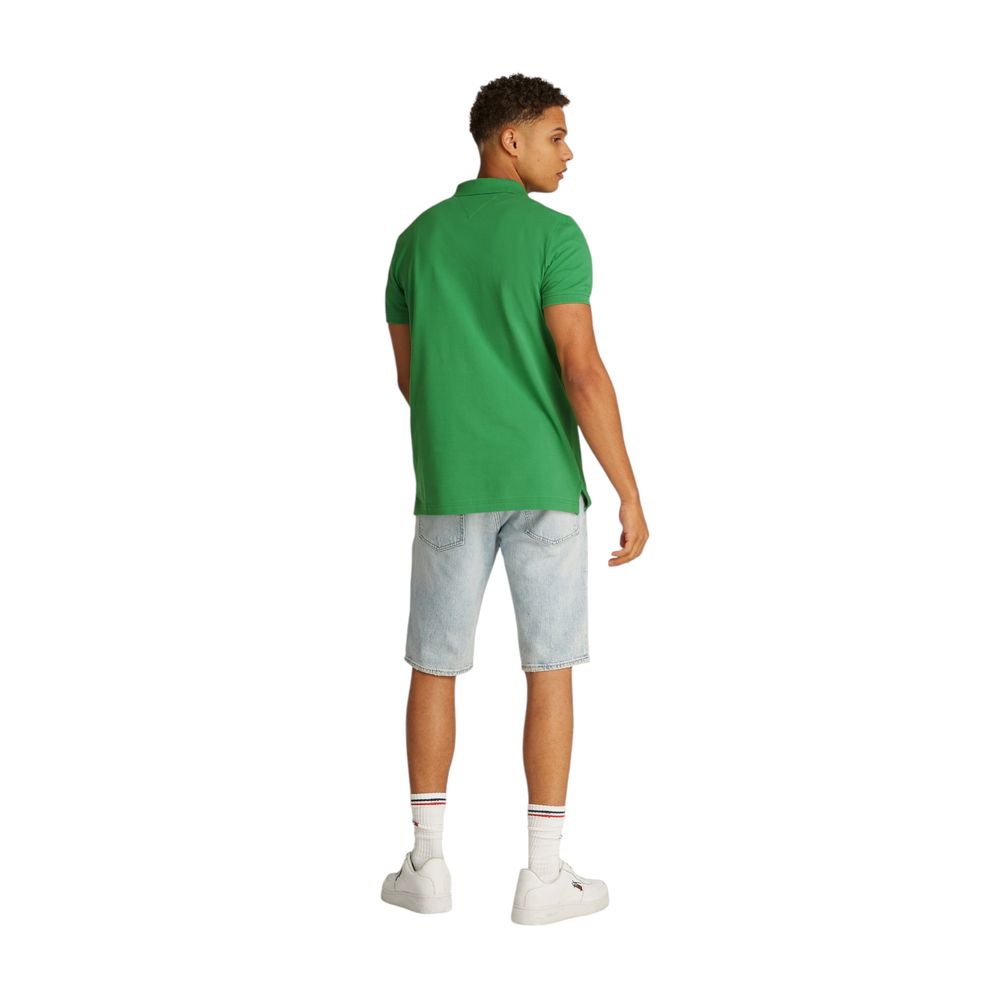Back view of man wearing Tommy Hilfiger Jeans Green Cotton Polo Shirt with denim shorts and white sneakers.