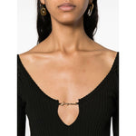 Close-up of JACQUEMUS Dresses Black featuring ribbed knit and gold-tone logo plaque neckline detail.