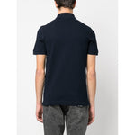 Back view of navy blue Dolce & Gabbana Logo cotton polo shirt with short sleeves and ribbed trim.