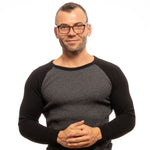 Man wearing Zadig & Voltaire Brown Men Glasses Frame with full-rim rectangle design, paired with a black and grey sweater.