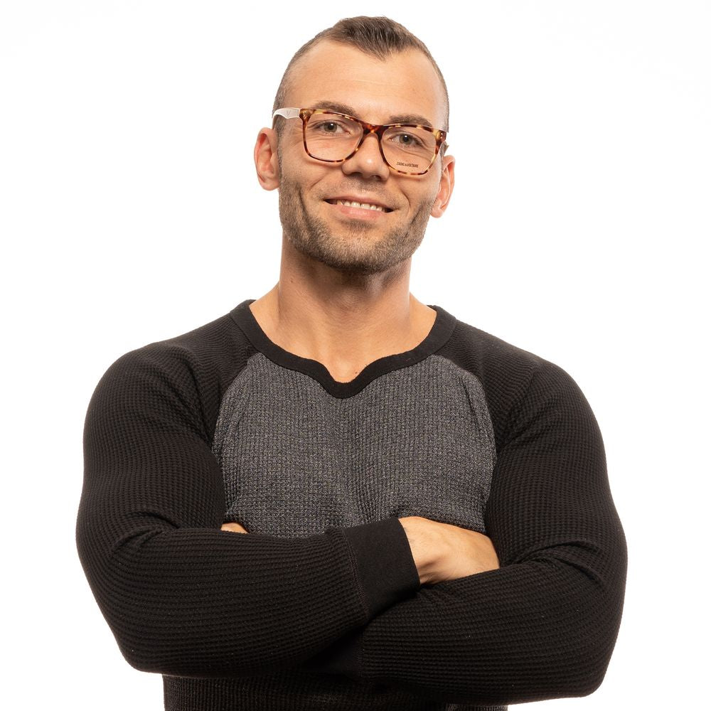 Man wearing Zadig & Voltaire Brown Unisex Glasses Frame, stylish full-rim rectangular design, captured with arms confidently crossed.