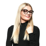 Woman wearing Swarovski Black Women Glasses Frame with full-rim black plastic frame, featuring 50-19-140 size and spring hinge.