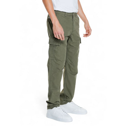 Jack Jones Green Cotton Cargo Pants with tapered fit and side flap pockets, worn by a model in white sneakers for casual style