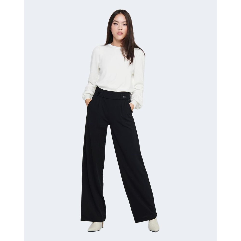 Woman wearing Jacqueline De Yong Black Polyester Pant with palazzo design and white blouse, showcasing a chic and versatile fashion look.