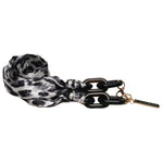 Stylish Guess eyewear chain with black and white leopard print scarf and gold logo tag.