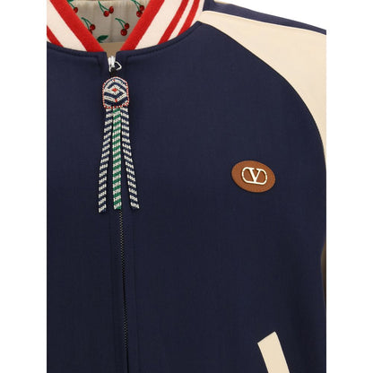 Close-up of Valentino Multicolor Fleece Wool Bomber with VLogo plaque and beaded zipper pull.
