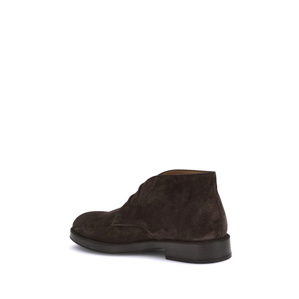 Rear view of Tod's Brown Calf Leather Bos Taurus Ankle Boots with rubber pebbles for grip and embossed monogram.