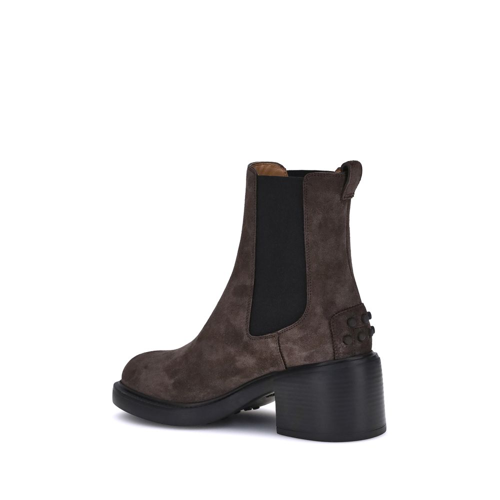 Tod's Brown Calf Leather Bos Taurus Ankle Boots with elastic inserts, embossed monogram, and rubber lug sole for style and comfort.
