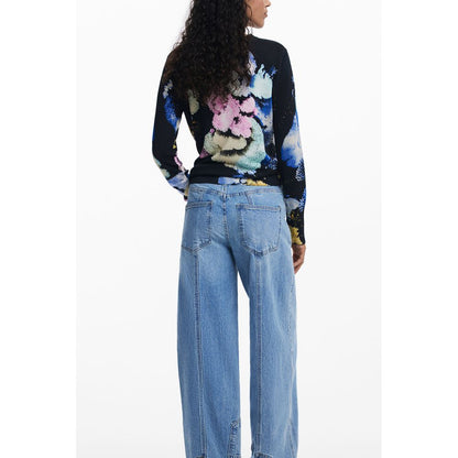Back view of model wearing Desigual Black Linen Women Sweater showcasing unique floral pattern and paired with relaxed blue jeans.