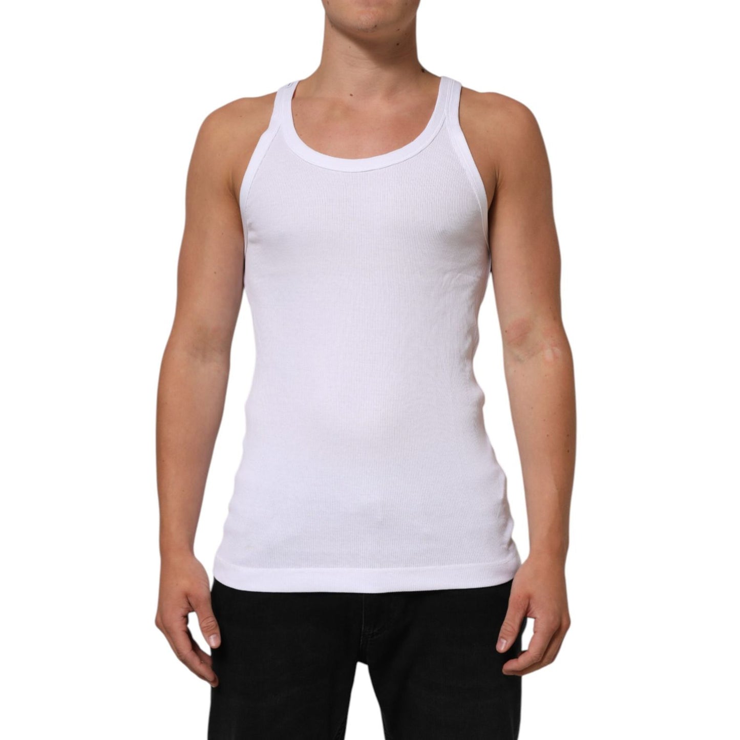 Person wearing Dolce & Gabbana White Sleeveless Round Neck Tank Top T-shirt made of 100% cotton with minor stain defect, regular fit, made in Italy.