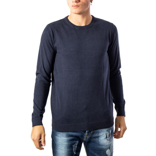 Model wearing Jack Jones Blue Cotton Sportswear sweater with knit crew neck, showcasing casual style with jeans for cooler seasons.