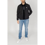 Armani Exchange Black Polyester Jackets & Coat on model, featuring contemporary style and functionality with zip closure and pockets.