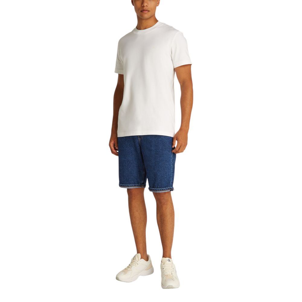 Man wearing Calvin Klein Jeans Blue Cotton Bermuda Shorts with white t-shirt and sneakers, ideal for casual summer style.