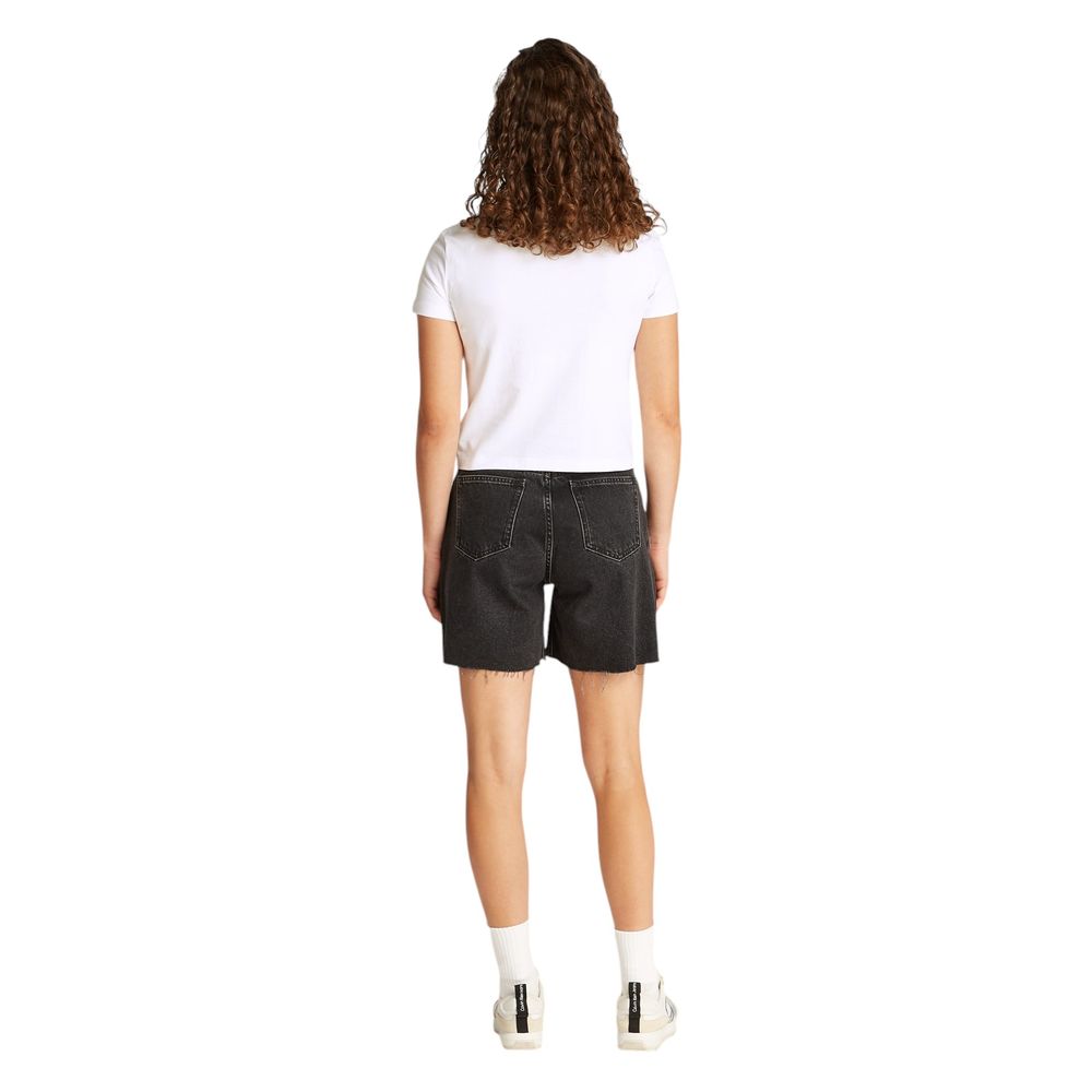 Back view of a woman wearing Calvin Klein Jeans White Recycled Cotton T-Shirt and black shorts, showcasing sustainability in fashion.