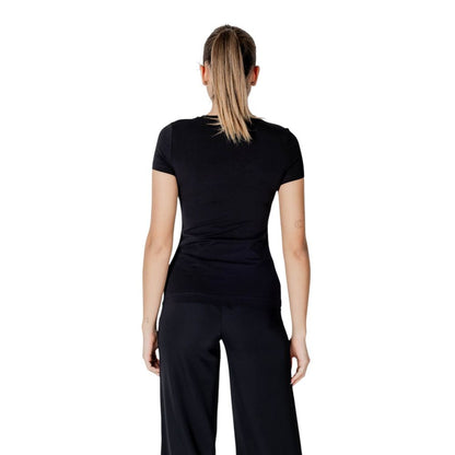 Back view of Guess Black Cotton T-Shirt worn by woman, showing slim fit and short sleeves.