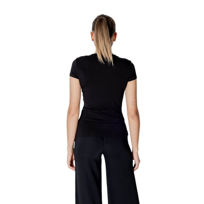 Back view of a model wearing an Armani Exchange Black Cotton T-Shirt with a slim fit design, showcasing elegance and comfort for women.