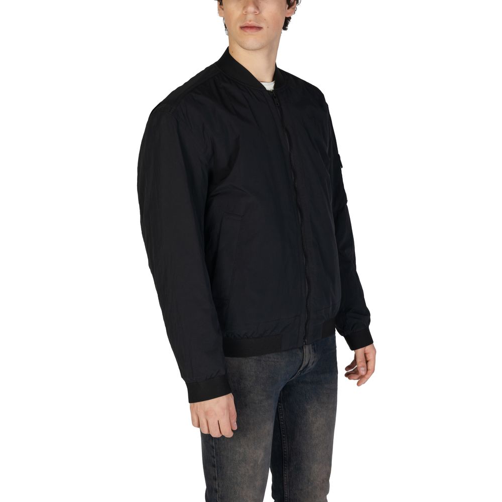 Man wearing Hugo Boss Black Polyamide Bomber jacket with ribbed collar and front zip closure.