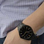 Gent wearing ARMANI EXCHANGE Mod. AX2144 wristwatch with stainless steel bracelet and mineral dial, showcasing elegant design.