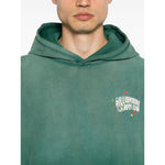 Billionaire Sweaters Green oversized hoodie with front logo and ribbed cuffs. Grass green color, worn by model standing.