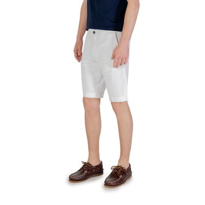 Man wearing Borghese White Cotton Bermuda Shorts and blue shirt, showcasing comfortable fit and versatile design.