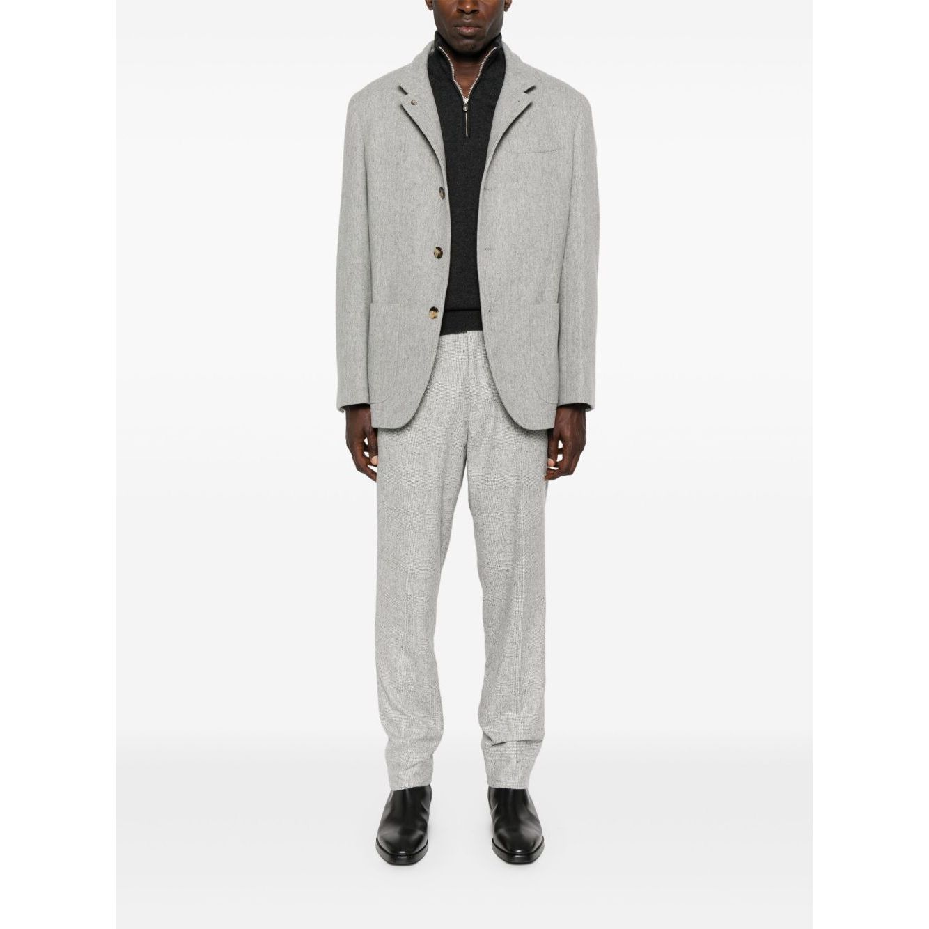 Model wearing grey Brunello Cucinelli Cashmere sweater with half front zip, long sleeves, ribbed cuffs, and high-neck.