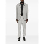 Model wearing grey Brunello Cucinelli Cashmere sweater with half front zip, long sleeves, ribbed cuffs, and high-neck.