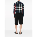 Back view of man wearing Burberry Summerton Shirt with black multicolor check pattern and black shorts.