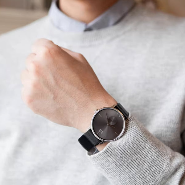 CALVIN KLEIN Mod. ACCENT wristwatch shown on wrist with stainless steel case and leather strap, elegant design for men.
