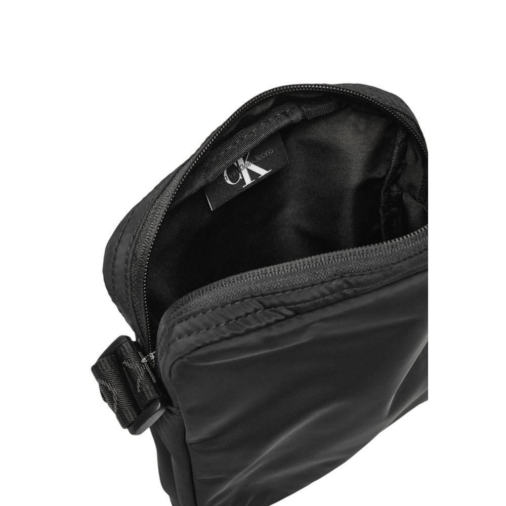 Interior view of Calvin Klein Black Recycled Polyester Messenger Bag showing zippered compartment and label.