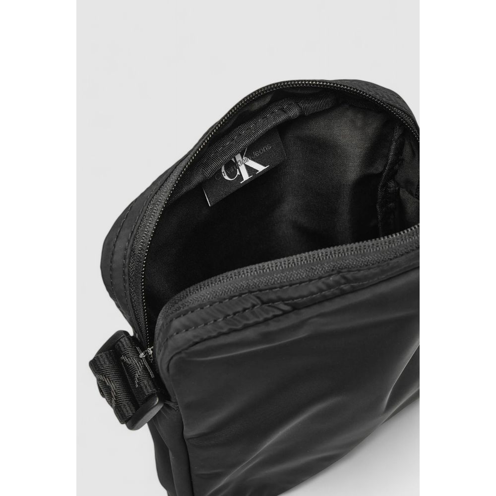 Calvin Klein Black Recycled Polyester Messenger Bag showing interior with zipper and adjustable strap