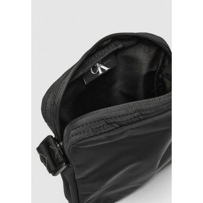 Calvin Klein Black Recycled Polyester Messenger Bag showing interior with zipper and adjustable strap