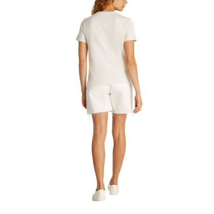 Back view of woman wearing Calvin Klein Jeans Beige Recycled Cotton T-Shirt with white shorts, showcasing a casual summer style.