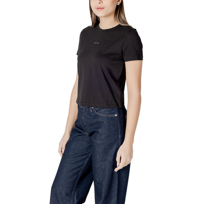 Woman wearing Calvin Klein Jeans Black Recycled Cotton Sportswear t-shirt with minimalist design and logo, paired with jeans.