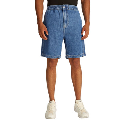 Male model wearing Calvin Klein Jeans Blue Cotton Bermuda Shorts, showcasing relaxed fit denim perfect for casual summer outings.