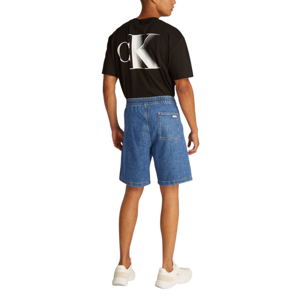 Back view of a person wearing Calvin Klein Jeans Blue Cotton Bermuda Shorts and black CK t-shirt, showcasing relaxed fit and summer style.