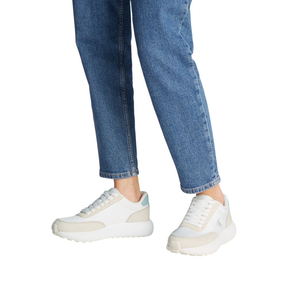 Calvin Klein Jeans Cream Leather Athletic Sneakers showcased with denim jeans, highlighting sporty style and urban elegance.
