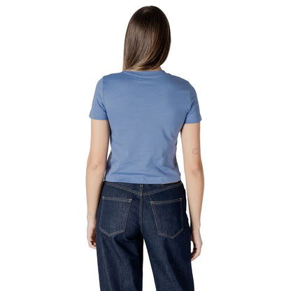 Back view of a woman wearing a Calvin Klein Jeans Light Blue Recycled Cotton Sportswear t-shirt in a minimalist design.