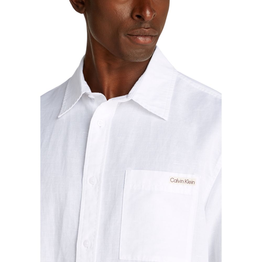 Calvin Klein Jeans White Linen Shortsleeve Shirt with chest pocket, ideal for summer, shown on model.