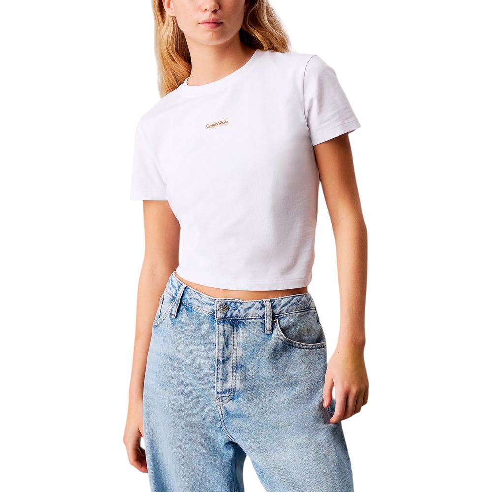 Woman wearing Calvin Klein Jeans White Recycled Cotton Sportswear t-shirt with jeans showcasing minimalist design and logo.