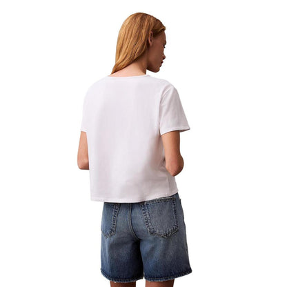 Back view of woman wearing Calvin Klein Jeans White Recycled Cotton T-Shirt and denim shorts.