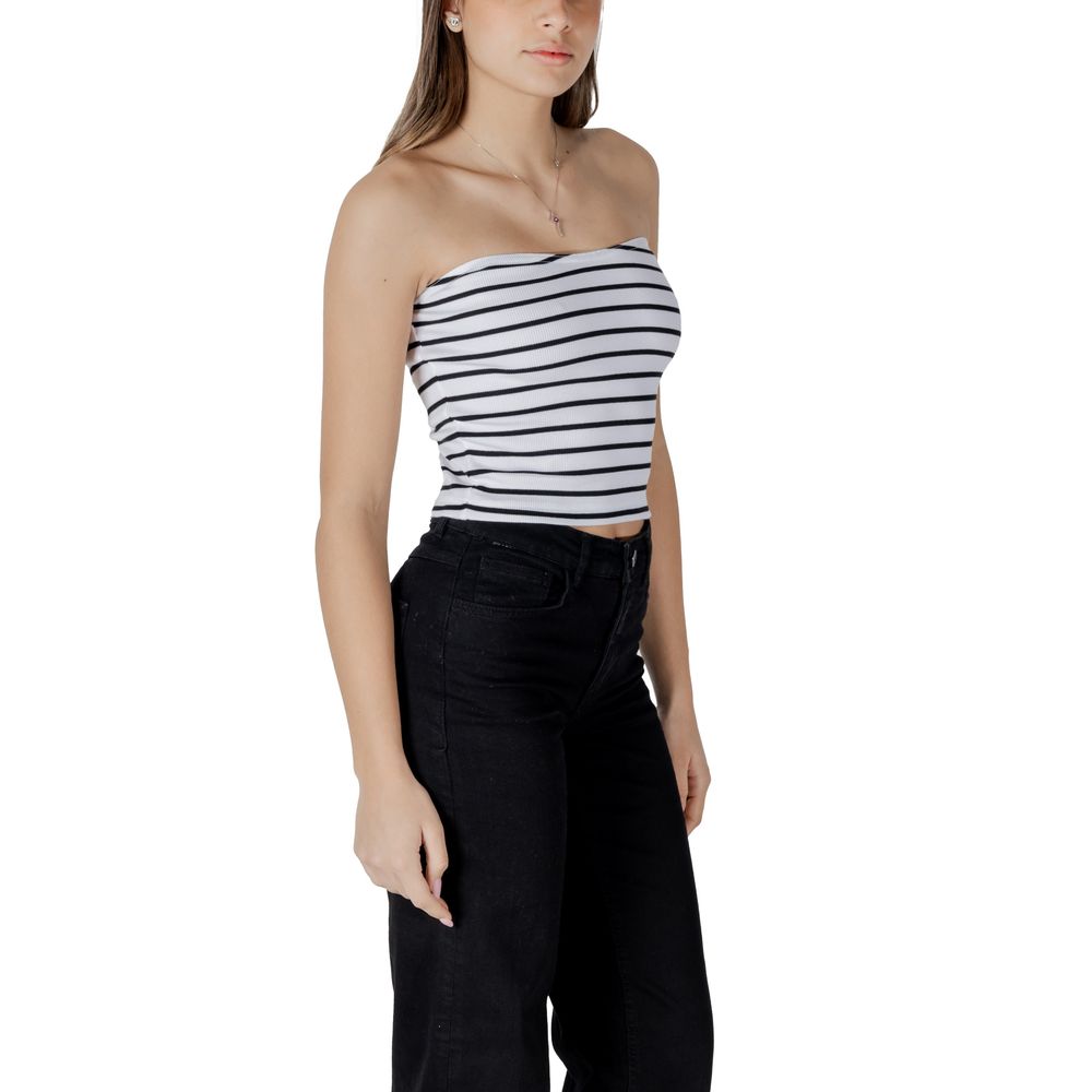 Woman wearing black and white striped sleeveless top with black pants, casual style outfit