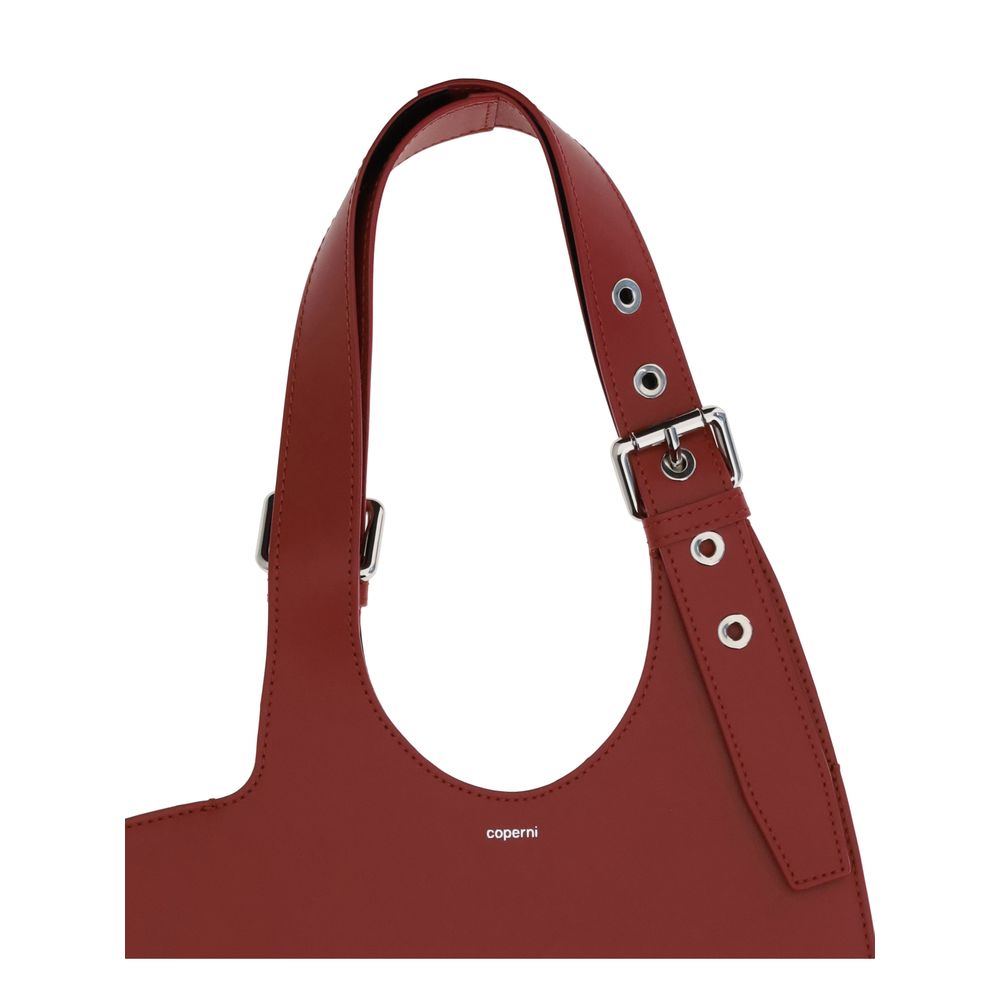 Coperni Bordeaux Calf Leather Bos Taurus Shoulder Bag with belted handle in bold red, AW25 collection, unique edgy accessory.