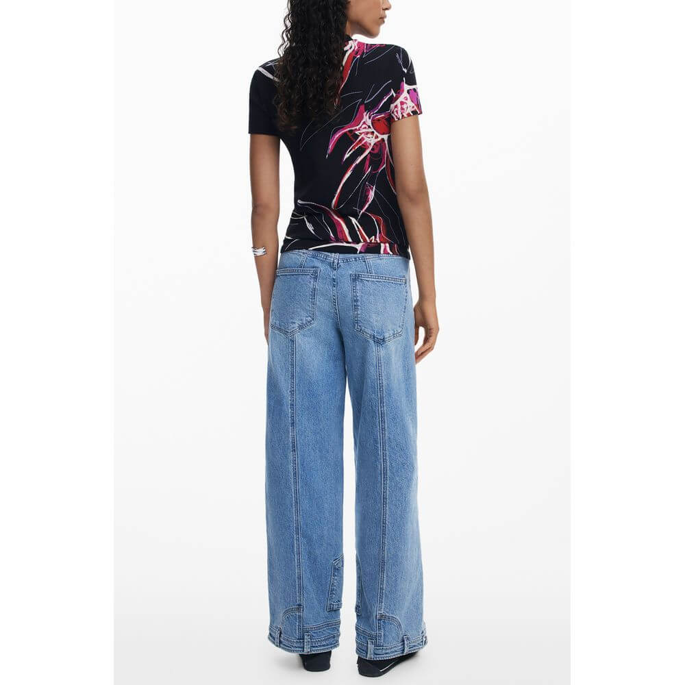 Back view of Desigual Black Viscose Women Top with signature print and wide-leg jeans.