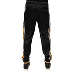 Back view of Dolce & Gabbana Black Gold Satin Crown Side Stripe Jogger Pants with crown embroidery and ribbed cuffs.