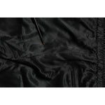 Close-up of Dolce & Gabbana Black Gold Satin Crown Side Stripe Jogger Pants fabric showcasing sleek satin texture.