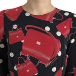 Dolce & Gabbana Black Sicily Bag Print Flared Midi Dress with red Sicily bag design, close-up of round neck and all-over print.