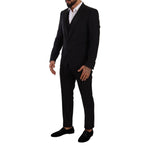 Model wearing Dolce & Gabbana Black Wool Suits & Blazer, slim fit, single-breasted with one button closure.