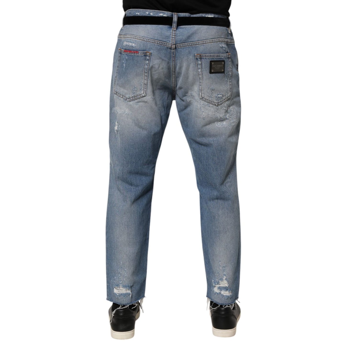 Back view of Dolce & Gabbana Blue Distressed Ripped Denim Trouser Jeans showcasing detailed distressing and logo plaque.