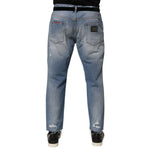 Back view of Dolce & Gabbana Blue Distressed Ripped Denim Trouser Jeans showcasing detailed distressing and logo plaque.